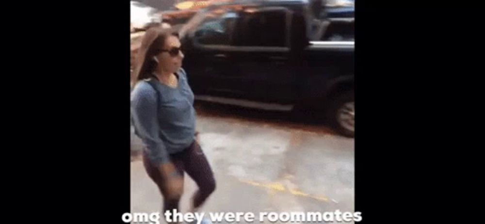 a woman is walking down a street with the words omg they were roommates in the corner .