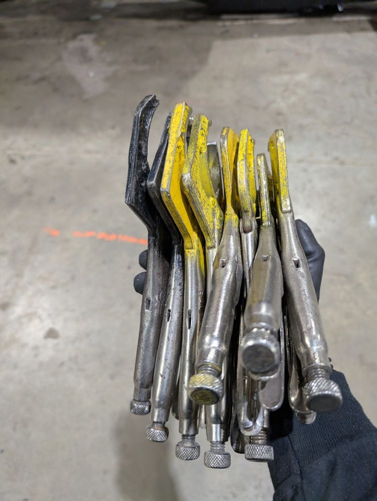 a handful of modified vice grips designed to clamp around a tube held over a concrete floor