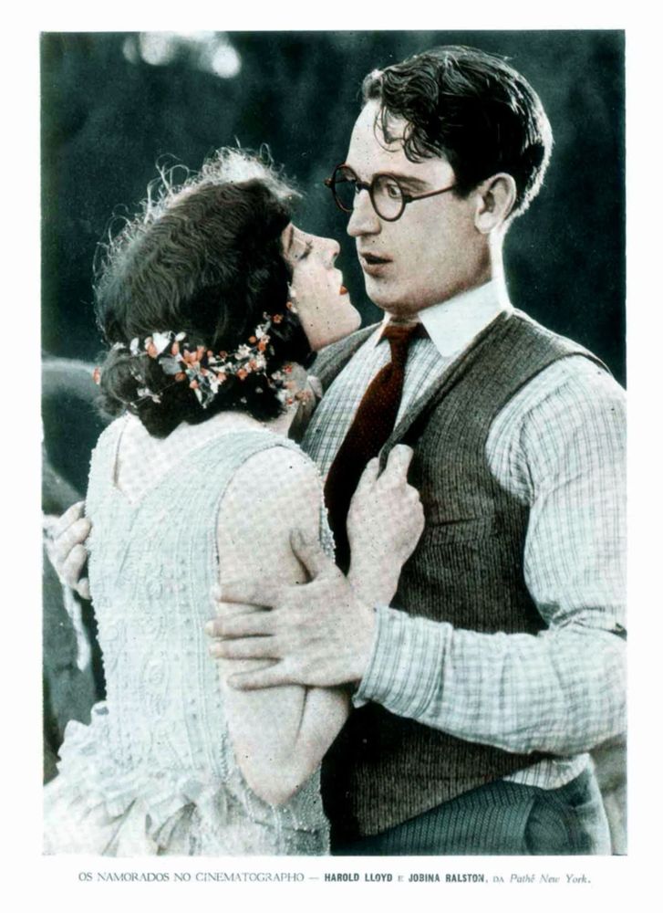 Old photograph of two people leaning into a kiss.