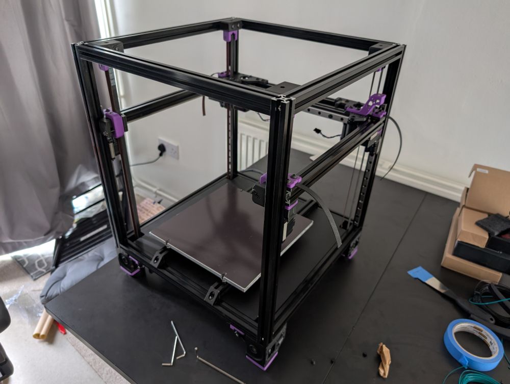 Photo of a partially assembled Voron 2.4 in black and purple
