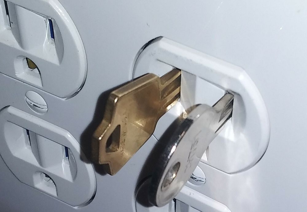A picture of a 110VAC power outlet with 2 in it, one of them being an A126 key, and the other a CH751 key. Nothing else is plugged into the outlet.