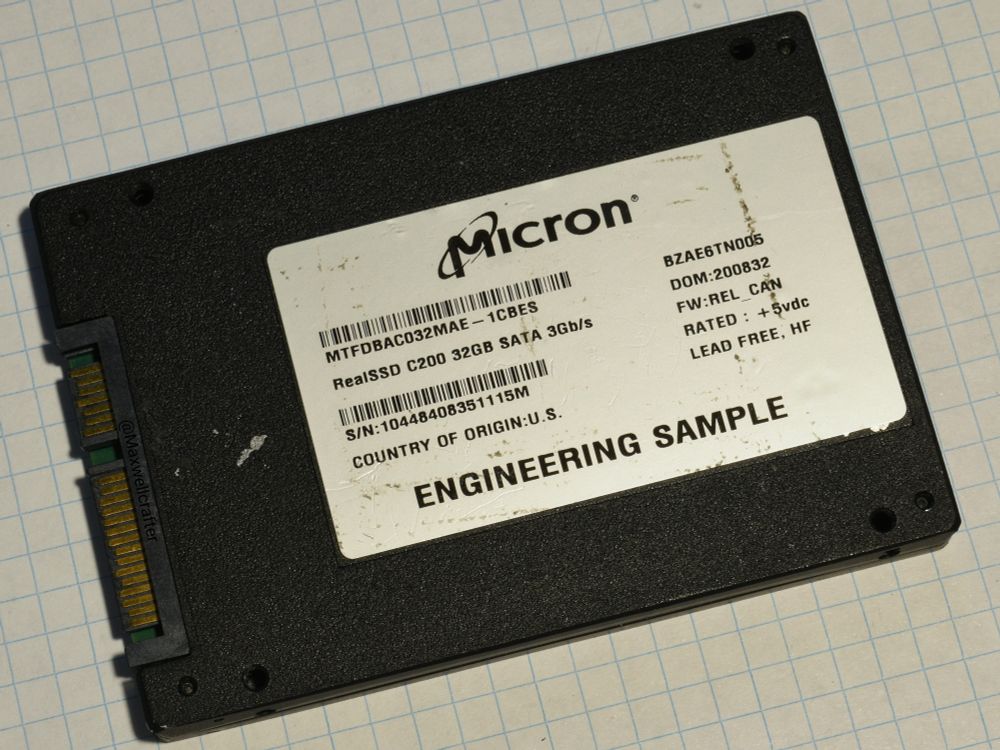 A photo of a 2.5" SATA SSD, with "Micron" branding, and the text "ENGINEERING SAMPLE" printed on it.
It is labeled "RealSSD C200 32GB SATA 3Gb/s", with a part number of "MTFDBAC032MAE-1CBES", and the serial number "10448408351115M".