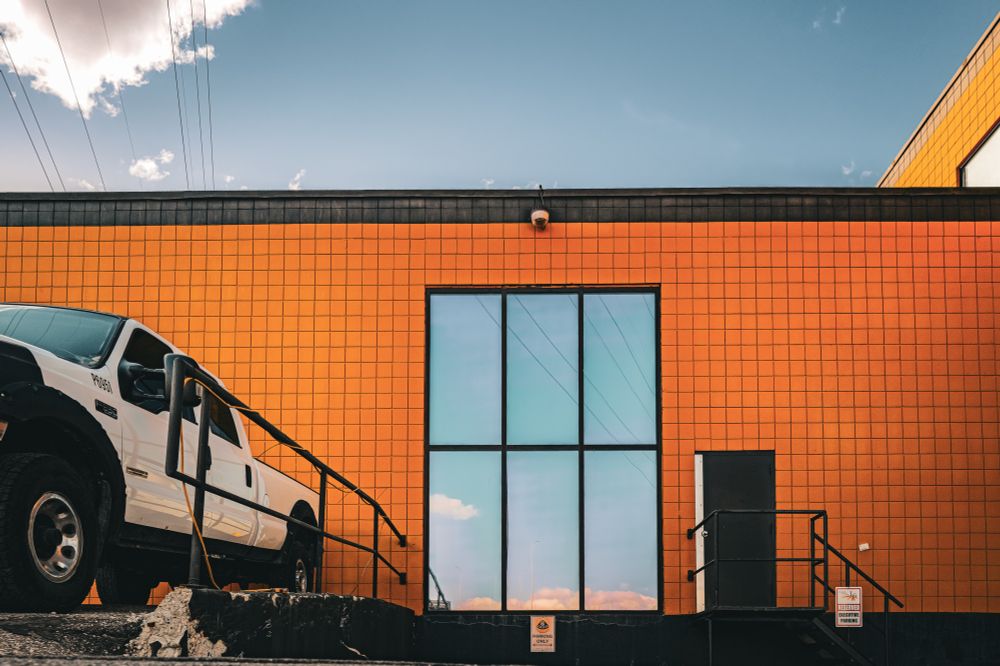 Reflective window in an orange wall