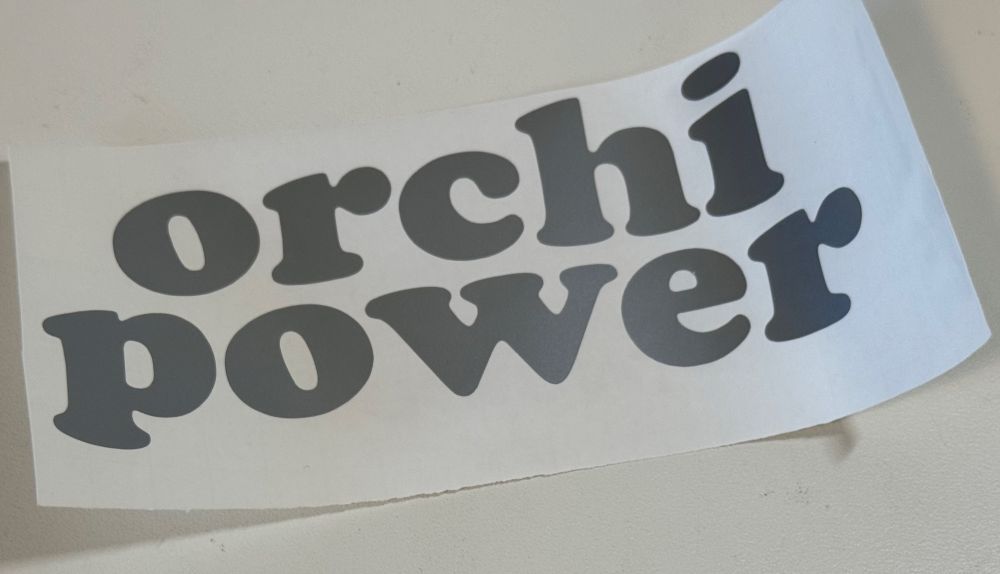 a vinyl cut sticker with the words “orchi power” in cooper black typeface 