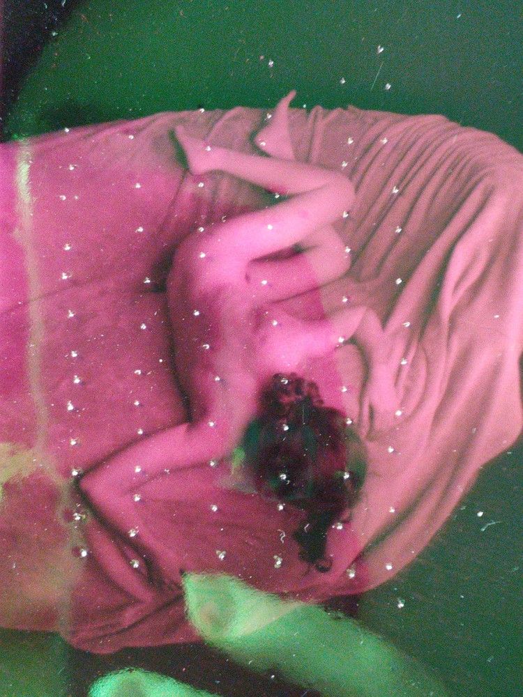 in camera pink and green color field laid over a woman falling off the couch