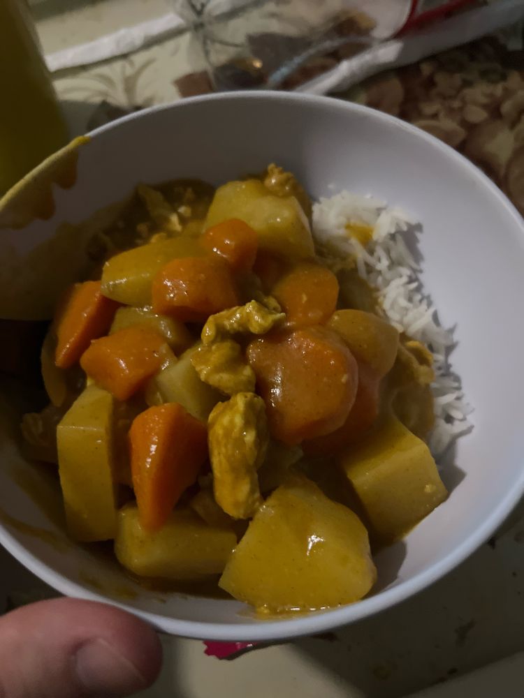 Curry with potato, carrots, chicken and rice 