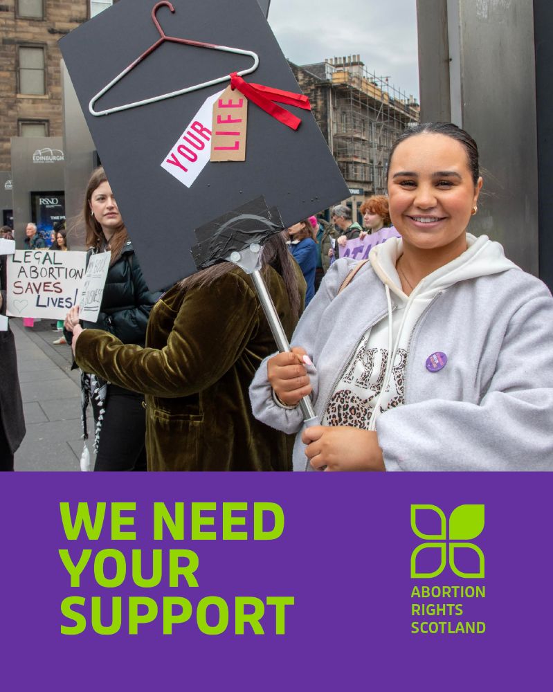 Placards saying "Legal abortion saves lives" and "Your life" attached with red ribbons to a coat hanger. WE NEED YOUR SUPPORT Abortion Rights Scotland