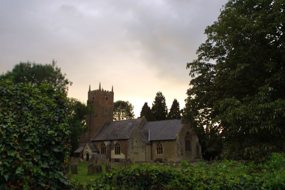 Kirklington church, back-lit by the setting sun.