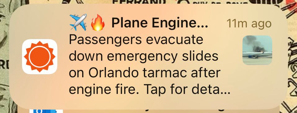 An AccuWeather app alert about an airplane engine fire on the tarmac in Orlando, Florida. 
