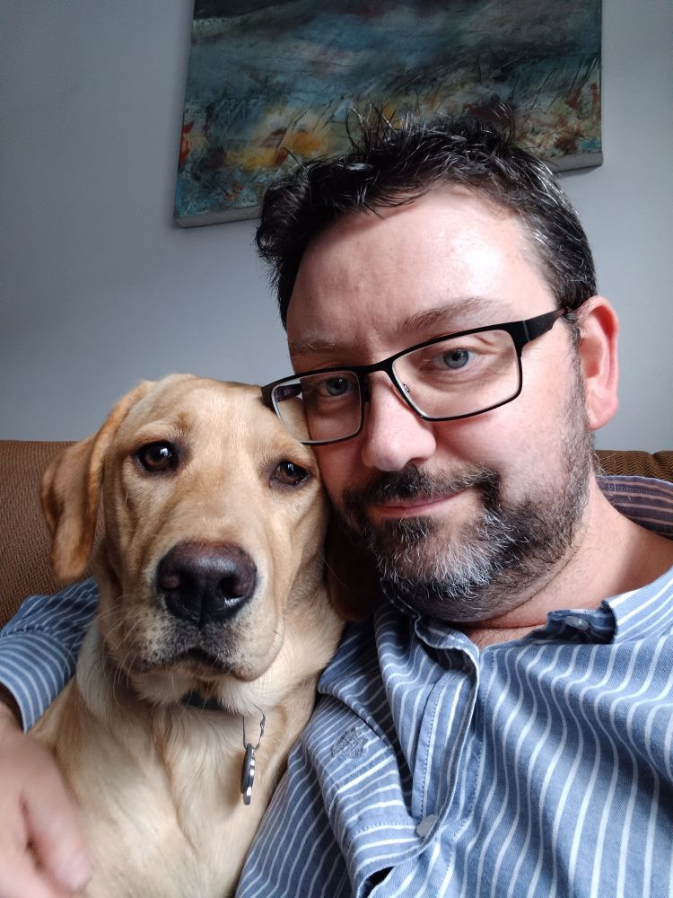 Selfie of Rob and Pip. Pip is a 7 month old yellow Labrador puppy