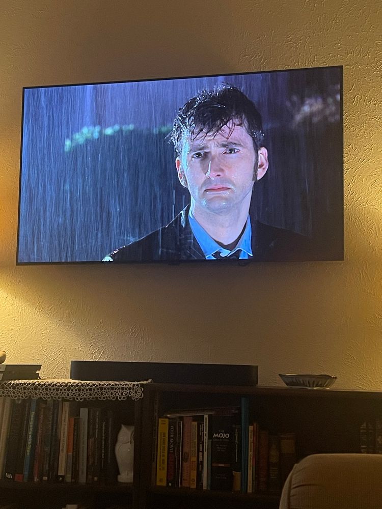 Tv screen with Tenth Doctor sad in the rain