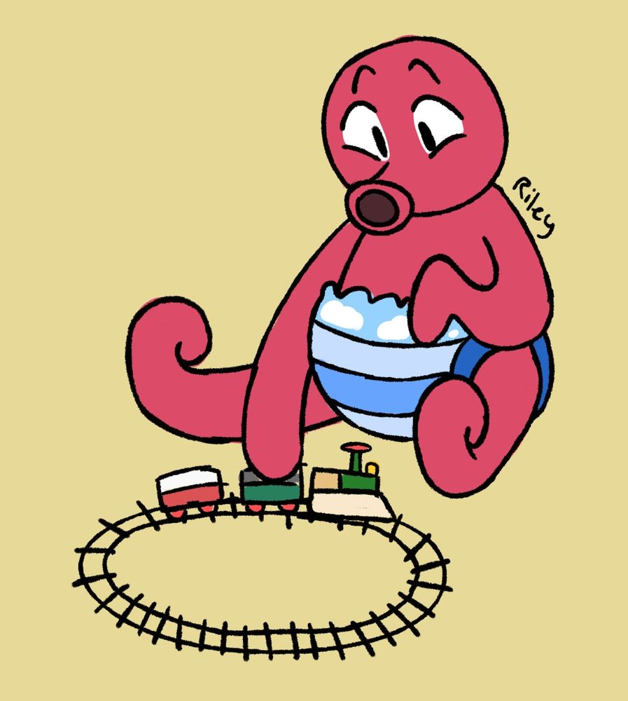 A red squid in a striped sky-blue diaper, playing with a train set