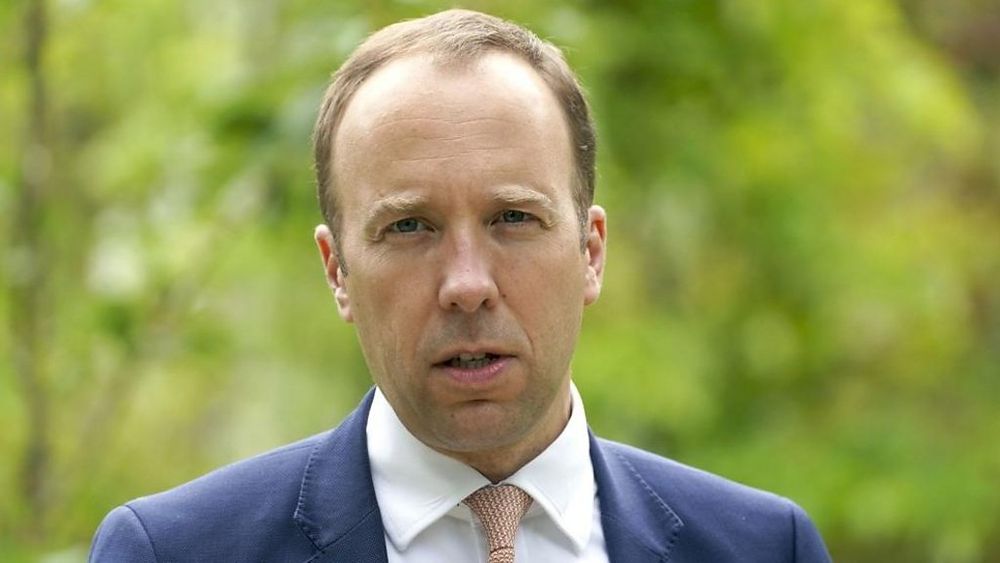 Balding man stares at the camera. 
His expression resembles that of a spaniel which is trying to understand Einstein’s theory of relativity. 