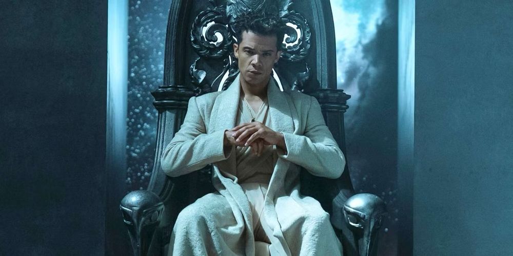 A man wearing all white, sitting on a throne 