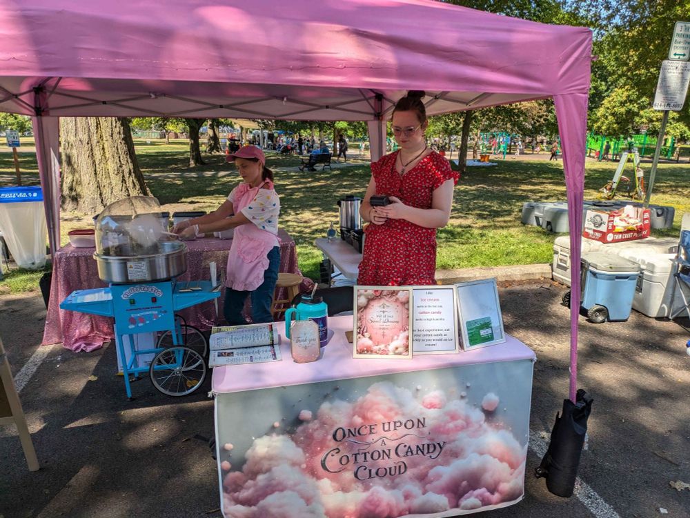 Two girls operating a cotton candy booth