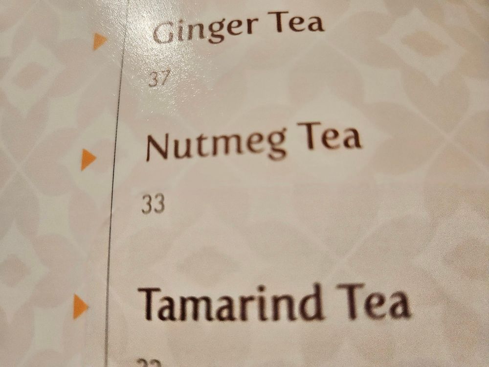 nutmeg ginger and tamarind tea on a brown white colored menu 