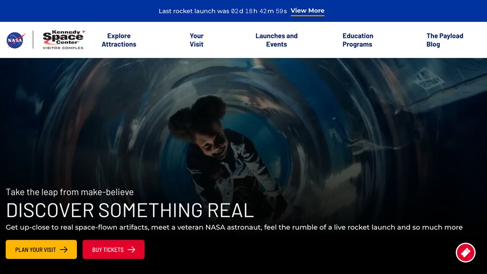 Screenshot of kennedyspacecenter.com. In the hero image, a girl with big afro puffs seems to be inside a spacecraft. The tagline is "discover something real" but I'm not convinced she's a real astronaut tbh because she looks about 10. 