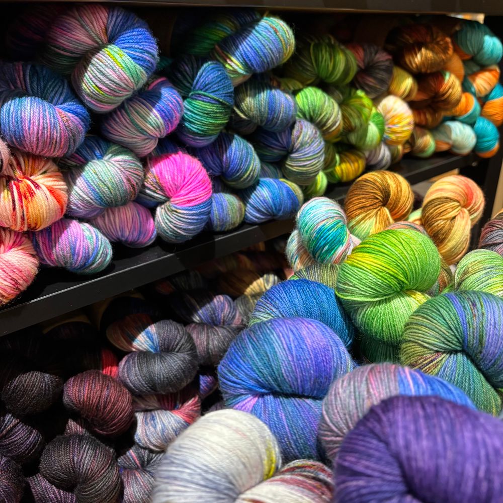 A variety of bright variegated skeins of yarn