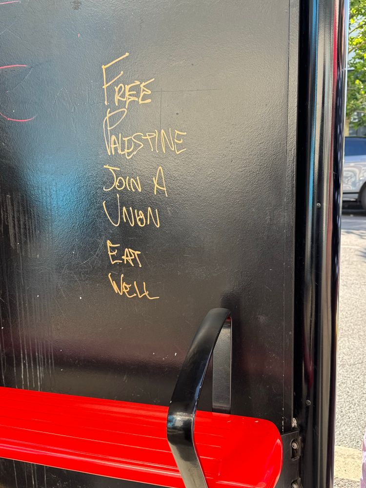 A sign at a London bus stop saying Free Palestine 🇵🇸 join a union eat well