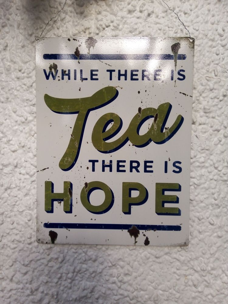 Sign with "While there's tea, there's hope" 