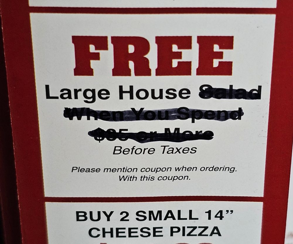 A photo of a coupon for a "free large house salad when you spend $35 or more" but everything following and including the word "salad" has been scratched out to read "free large house" instead