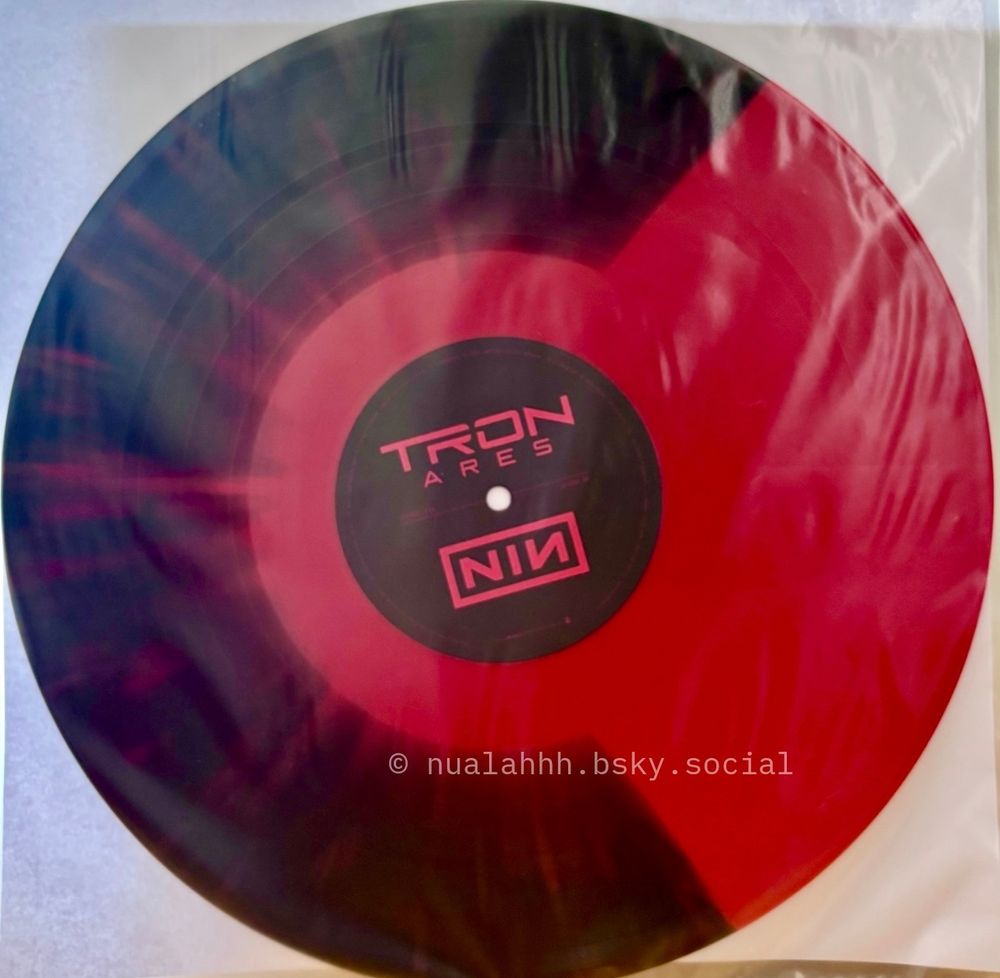 A Nine Inch Nails black and red vinyl record that appears to have the criterion collection logo C on it. 