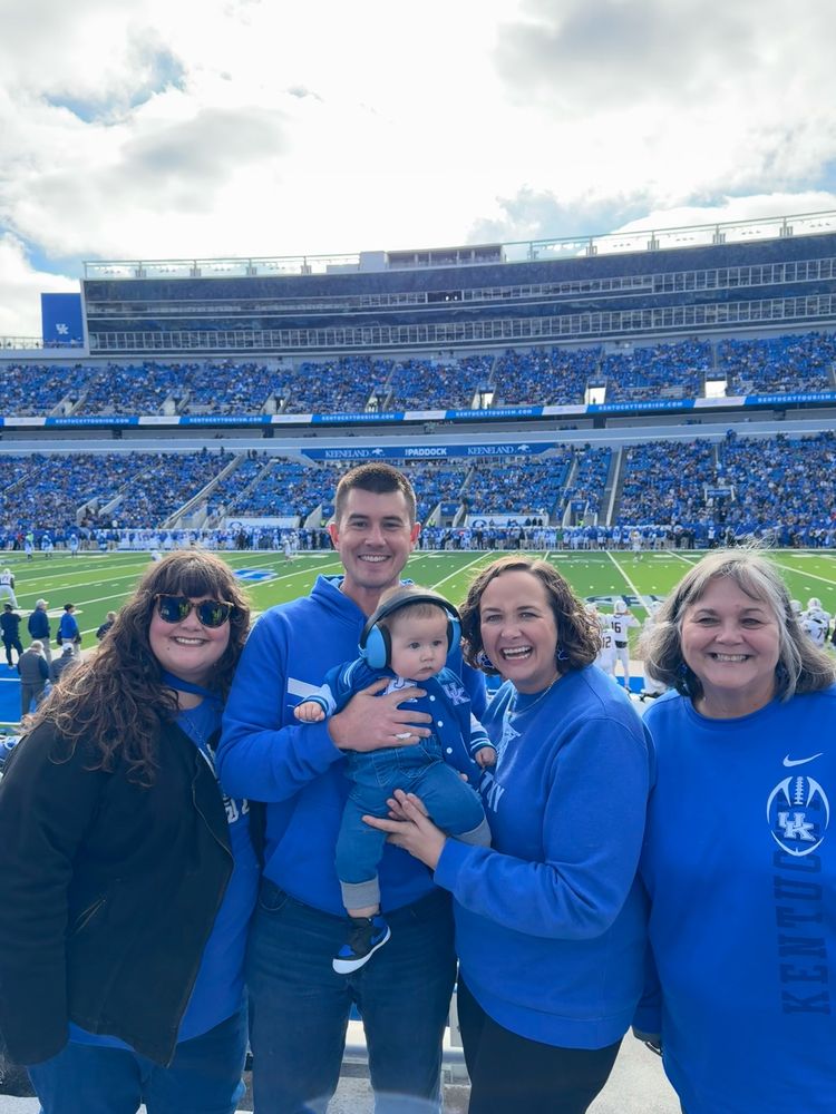 Family pic in front of football field 