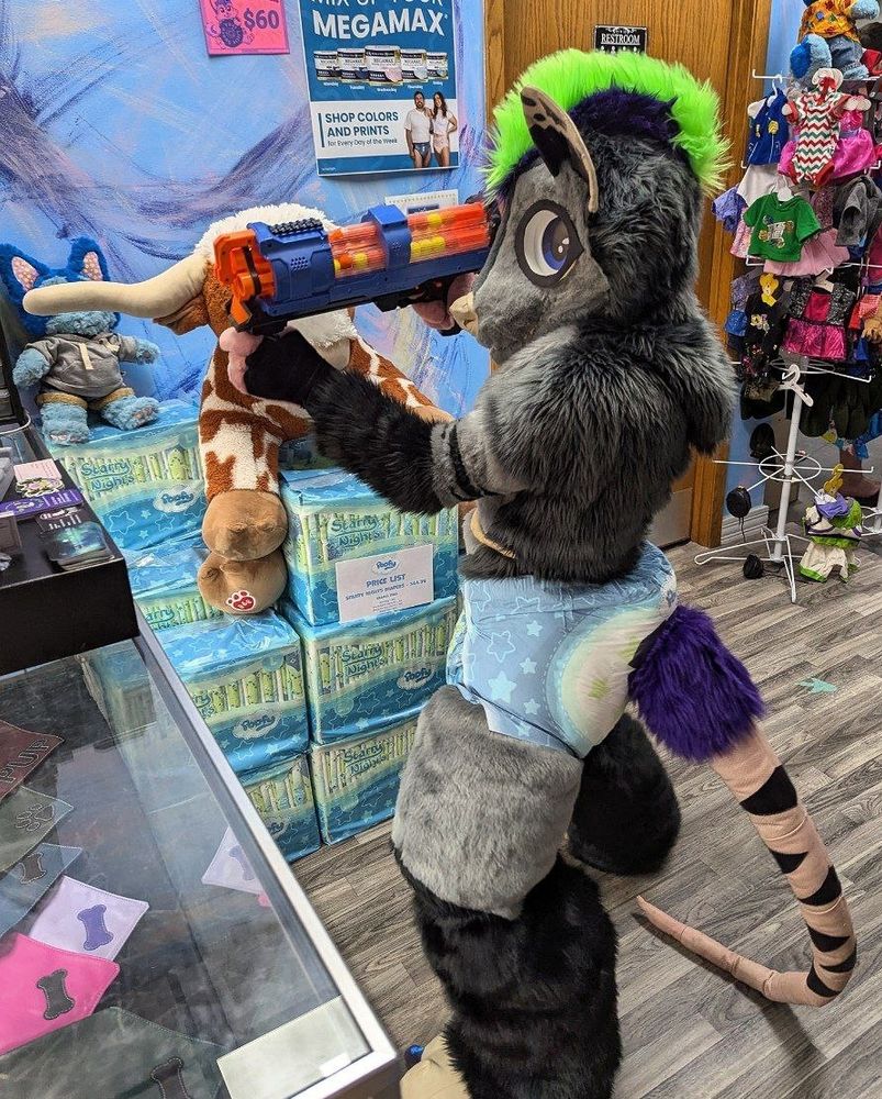 This is a robbery (said in baby voice)
I'm here to steal all the pamps!

Opossum suiter wearing PoofyPins starry nights pamps holding a ball shooting nerf gun.
Register staff at nerf point lol