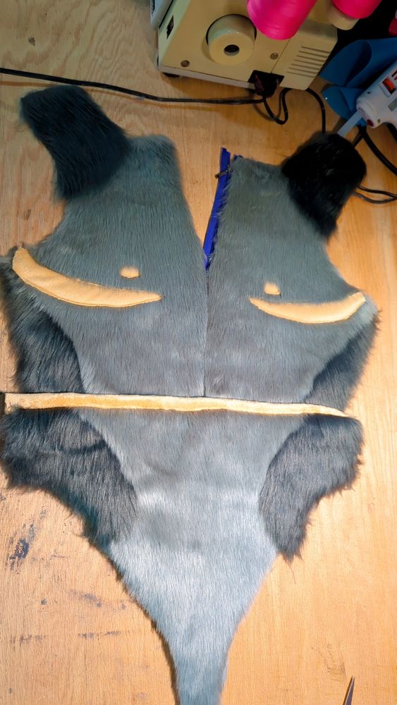 A full front picture showing both sides with the top surgery scars and nips as well as showing where the zipper will be (purple) and the lined front pouch!
