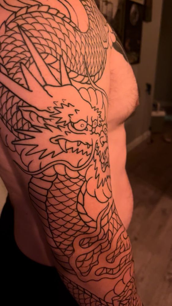 Dragon still needs one more claw and the background is unfinished. Originally posted by Glittering_Tie_3744 on r/tattooadvice on December 10th, 2025.