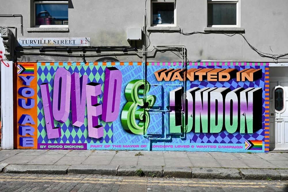 Very jazzy colourful mural, 'You are loved and wanted in London', big retro bubble text in blues and purples