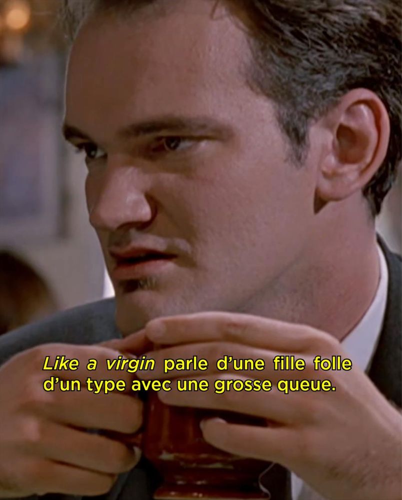 Image issue du film « Reservoir Dogs » où Quentin Tarantino s'exclame : « Like a virgin parle d'une fille folle d'un type avec une grosse queue».