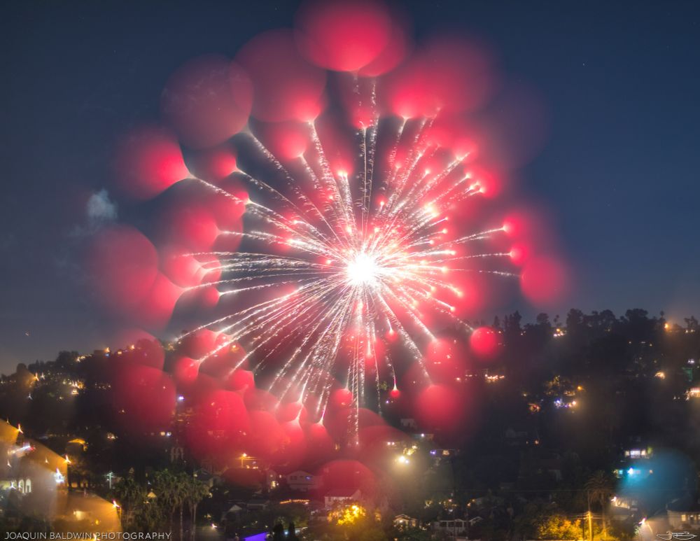 A soft smear of red fireworks like the feathers of a hellish peacock.