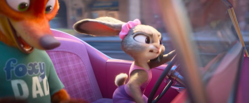 Screenshot from the Zootopia 2 trailer showing Nick wearing a Foxy Dad tshirt and Judy wearing a pink tank top, driving a pink car.