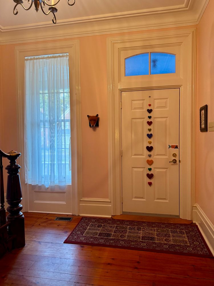 Entry way of 1870’s house with string of hearts on the inside of the door.