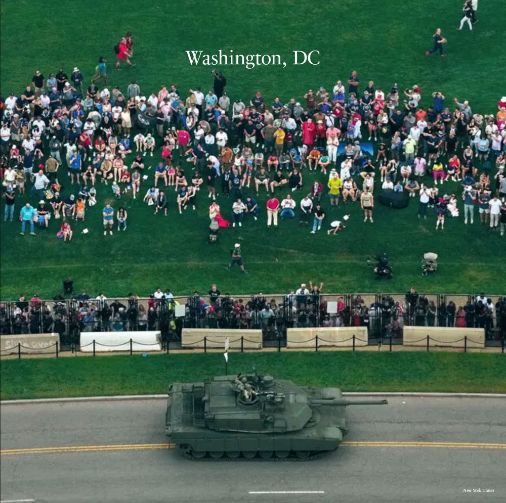 A tank driving by a sparsely populated hill of spectators in Washington DC
