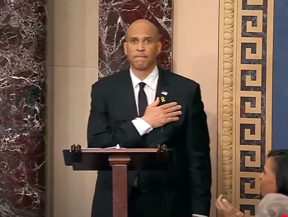 Sen. Cory Booker putting his hand over his heart as he beats Strom Thurmond's floor address record