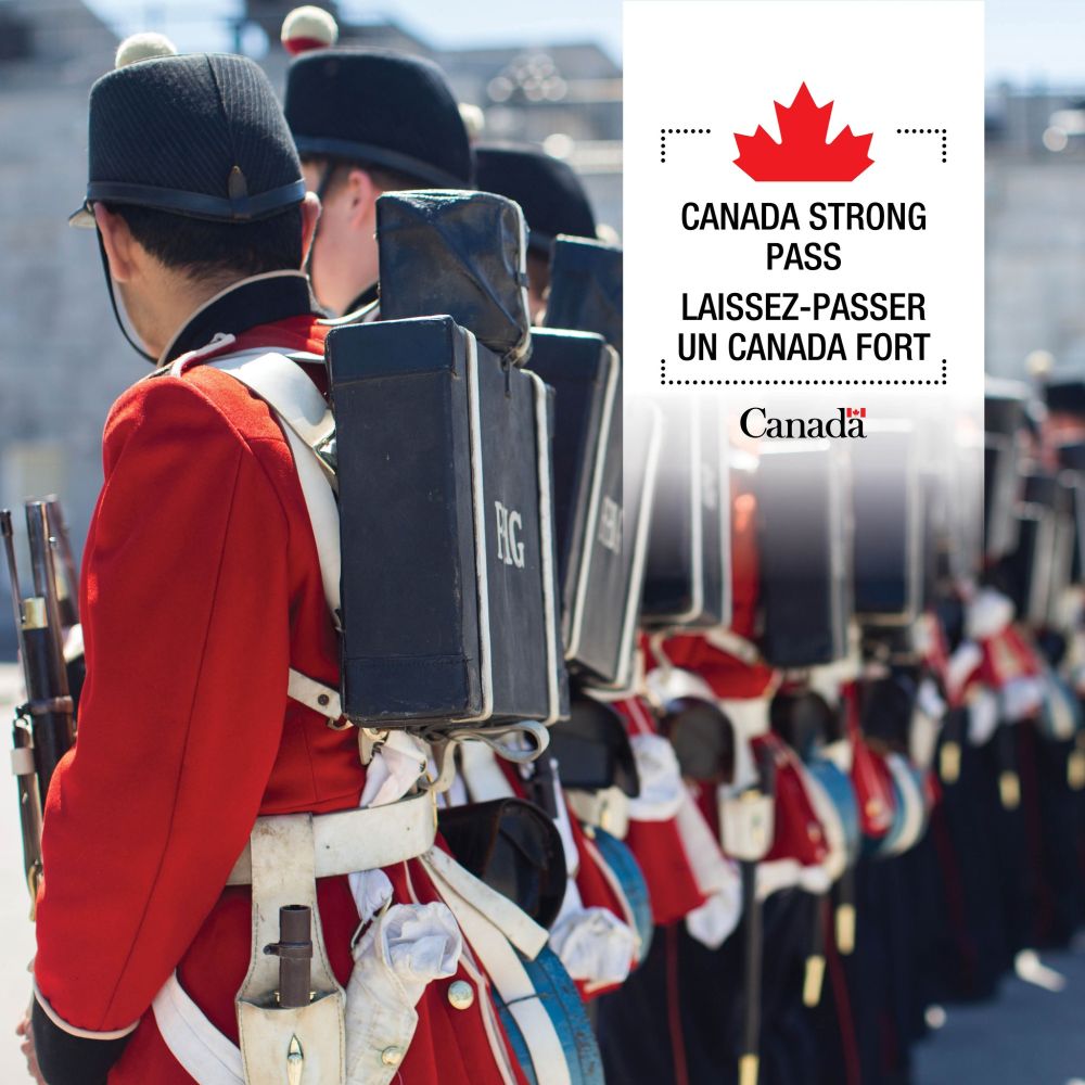 A line of soldiers in traditional red uniforms and black hats stands in formation, each carrying a black backpack labeled 'RG'. To the right, a white box features a red maple leaf and the text: 'CANADA STRONG PASS / LAISSEZ-PASSER UN CANADA FORT' with the word 'Canada' and a small maple leaf below.