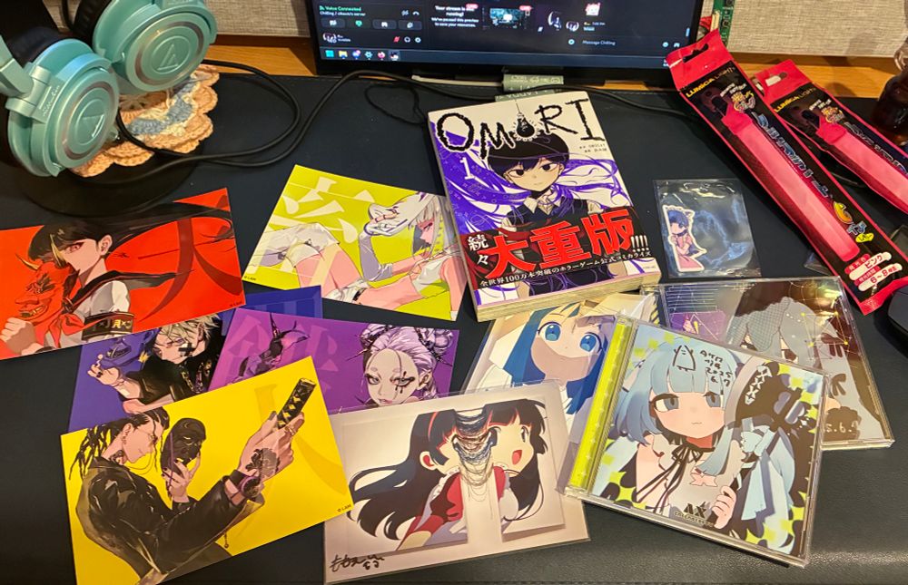 A bunch of merch from postcard, cd music and comic