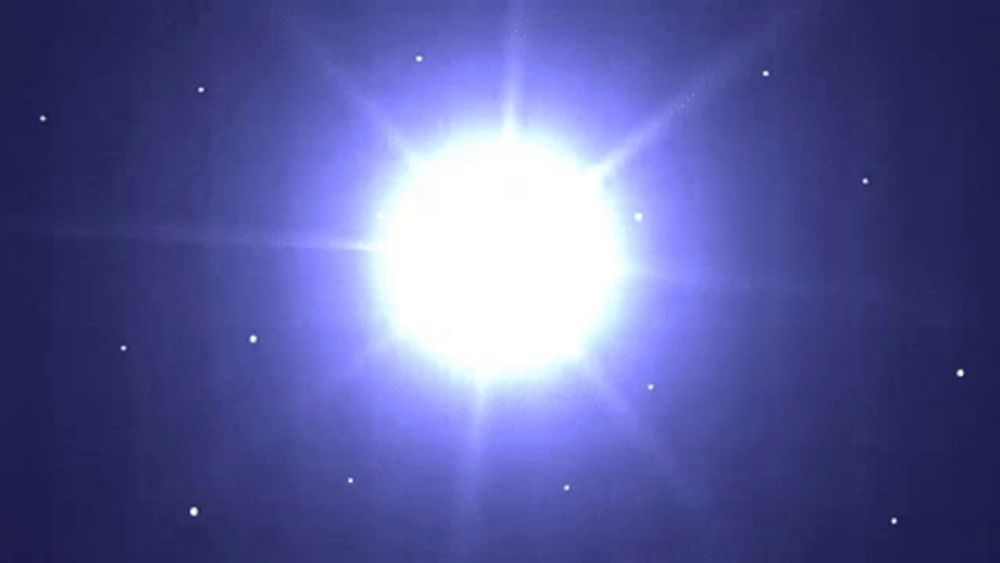 a bright white star is surrounded by smaller stars in a blue sky