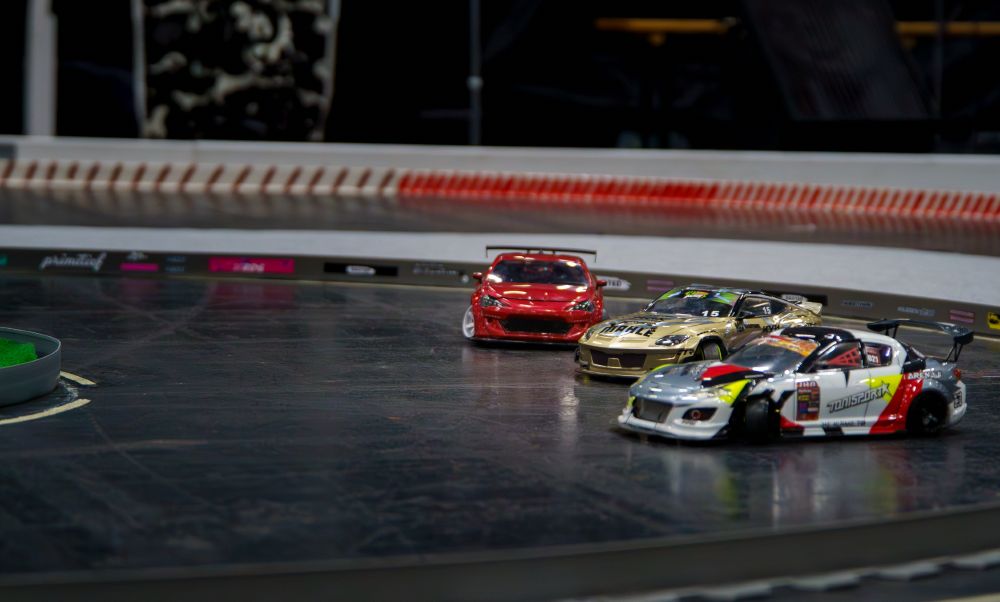 a picture of RC drift cars on track at Gamescom 2025