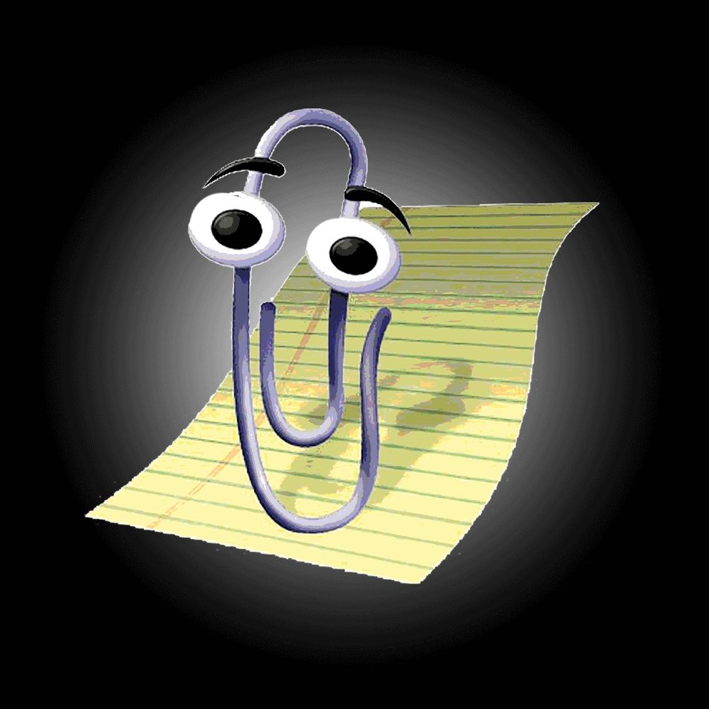 Image of clippy the assistant. A slightly anthropomorphic paper clip sitting on a yellow paper 