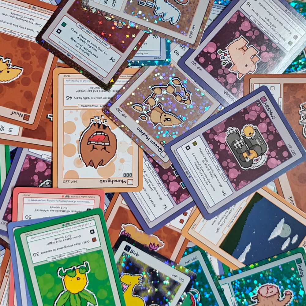 pile of trading cards with various colorful monsters on them