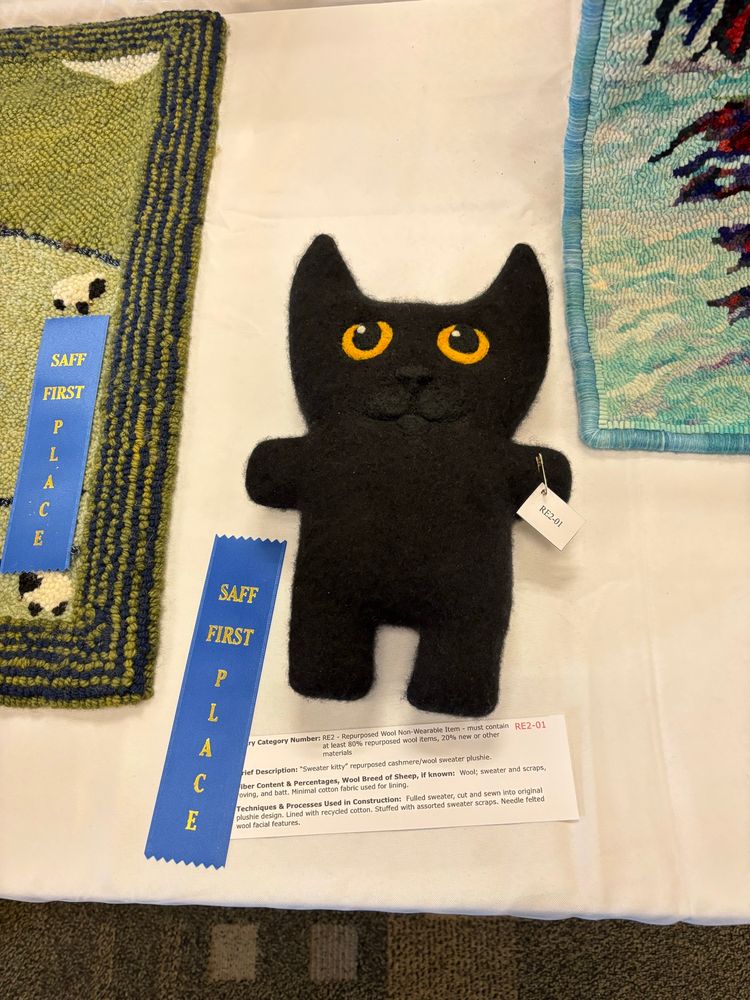 Repurposed sweater plushie winning 1st place in the recycled non wearables category at SAFF