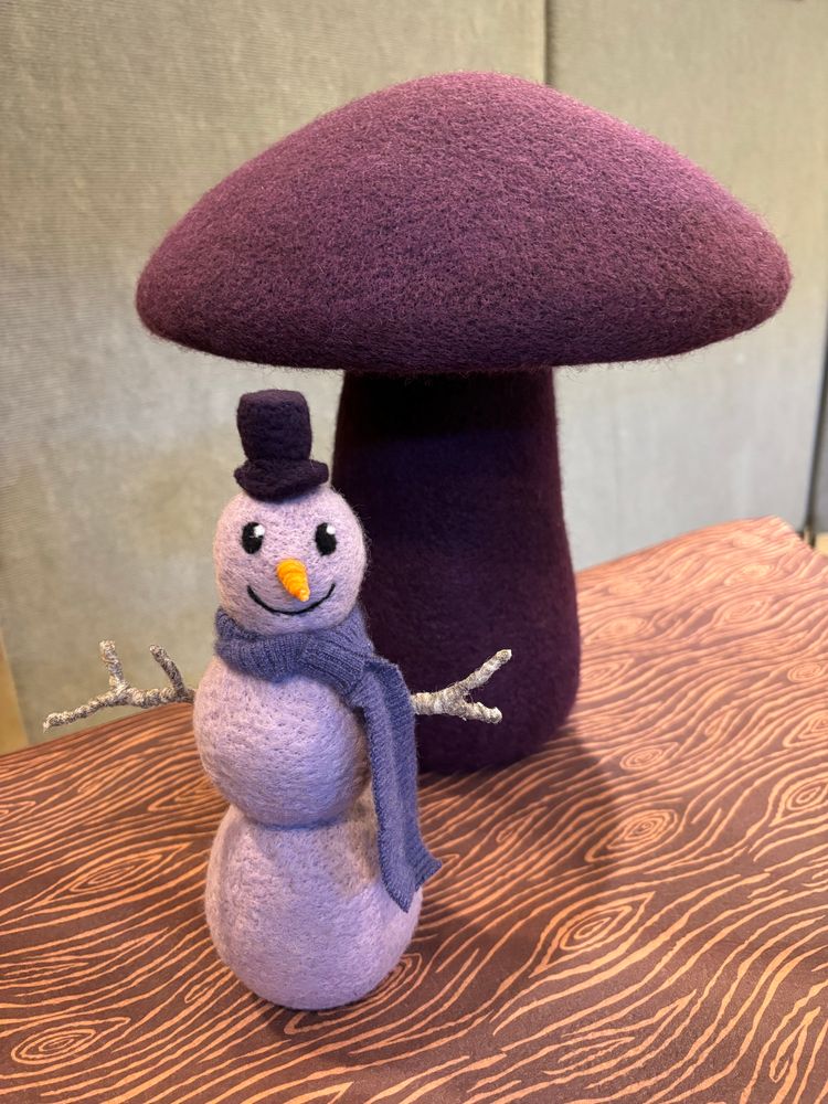 Needle felted wool sculptures of a snowman and mushroom.
