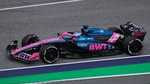 Pink & blue formula one race car belonging to Team Alpine racing