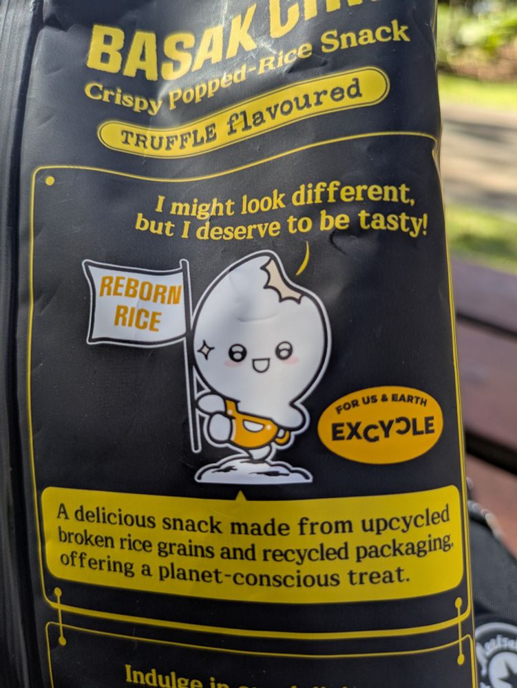 Back of packet of rice snacks with animated snack holding a sign saying 'reborn rice'