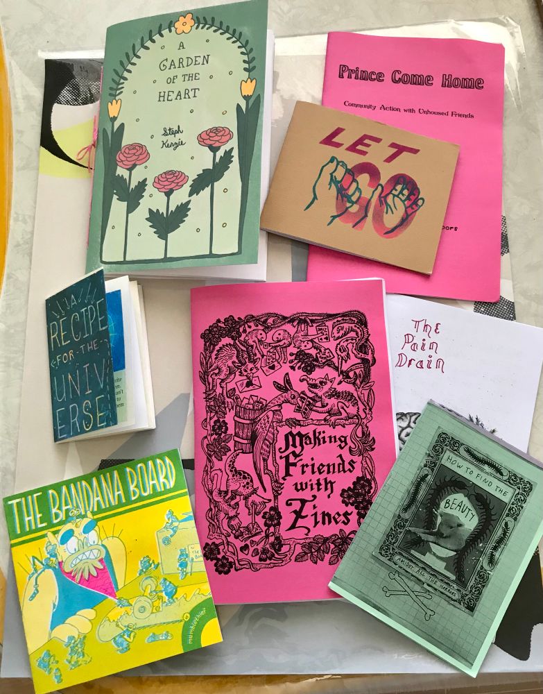 An image of a bunch of zines on top of a poster