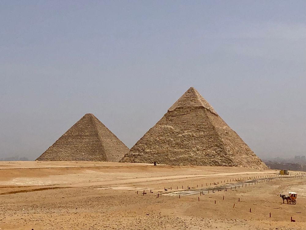 Two pyramids against a light grey sky