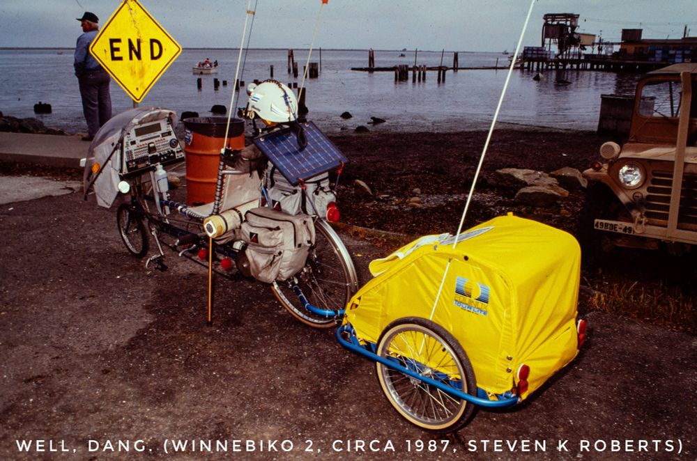 Winnebiko 2 computerized recumbent bicycle at a shore, parked in front of an END sign. Taking some time in 1987, about midway during the technomadic adventures. 